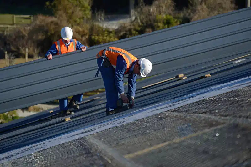 two roofers working on roof replacement 