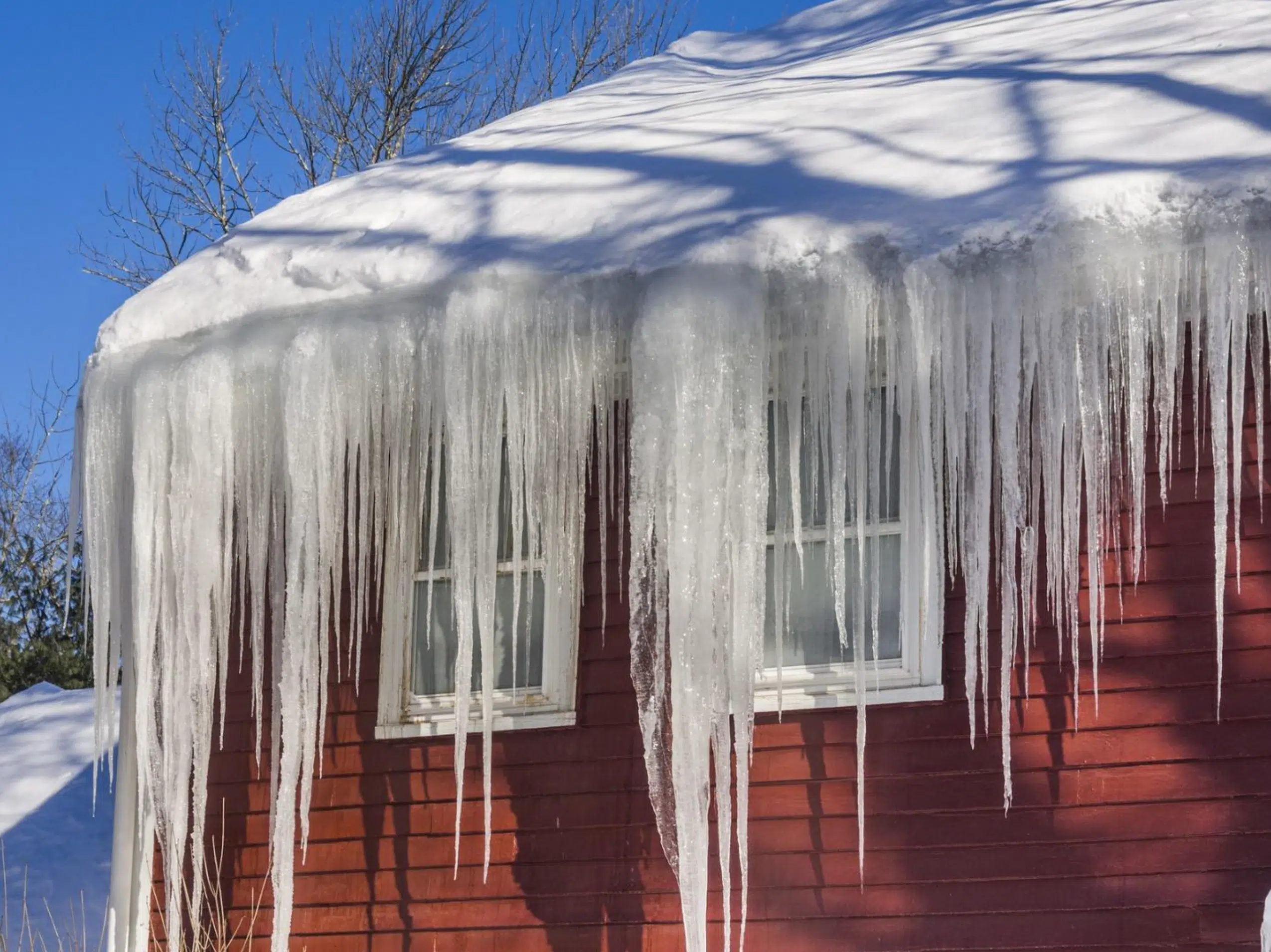 House with ice on its roof in the winter season