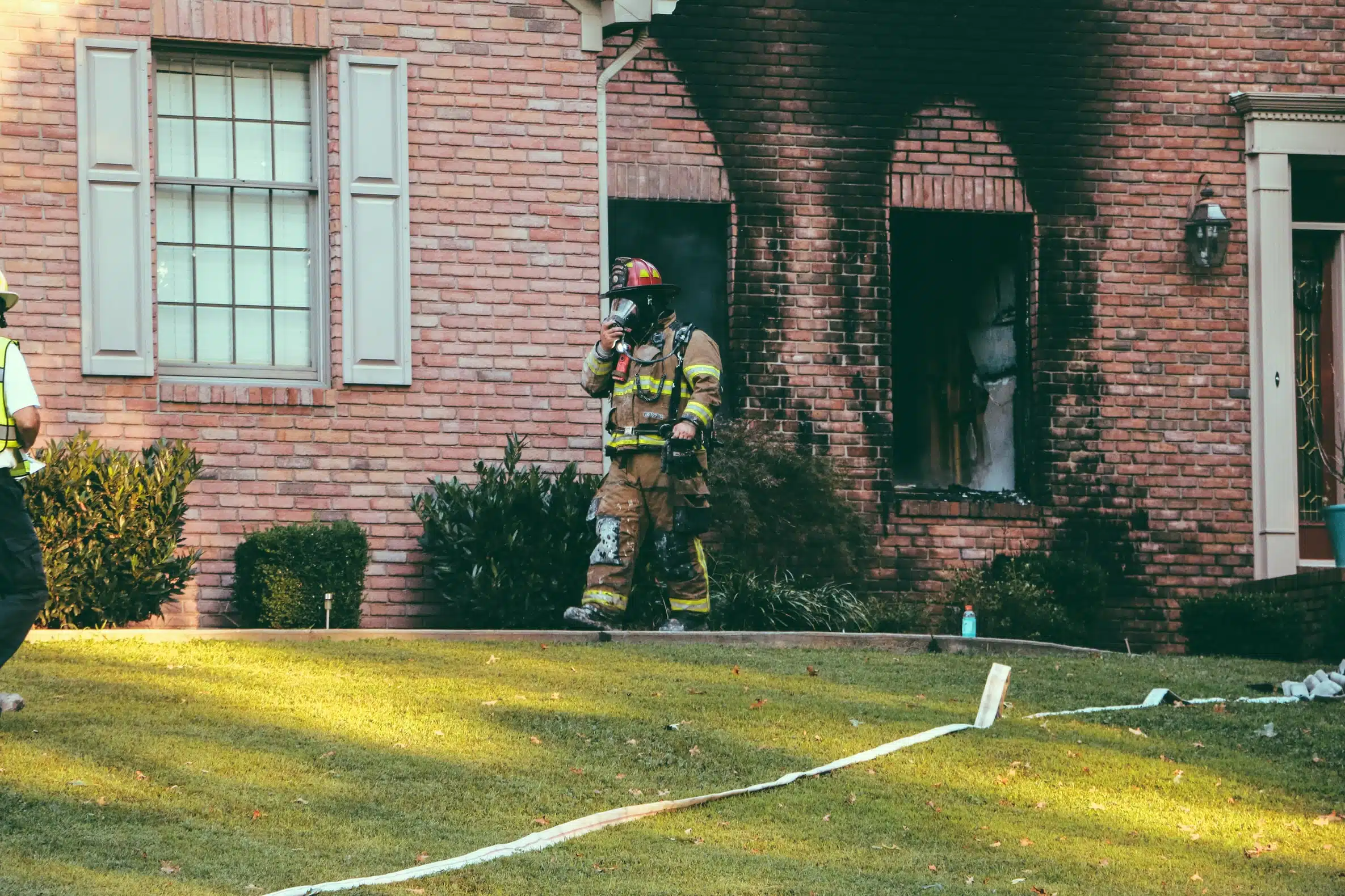 Firefighter on duty in the area of a house that caught fire.