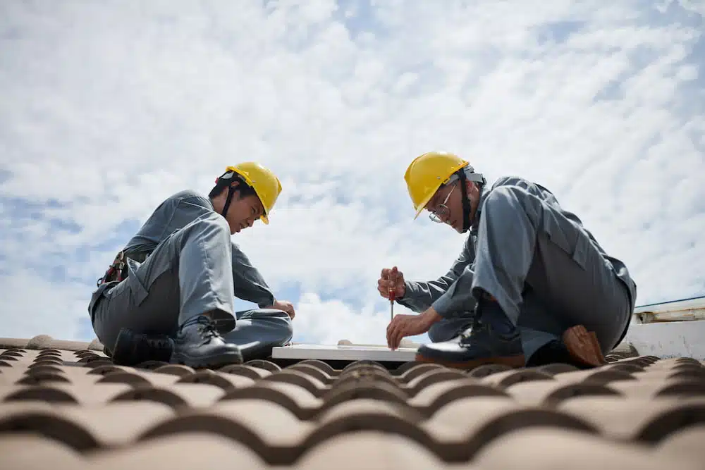 Two People Repairing roof