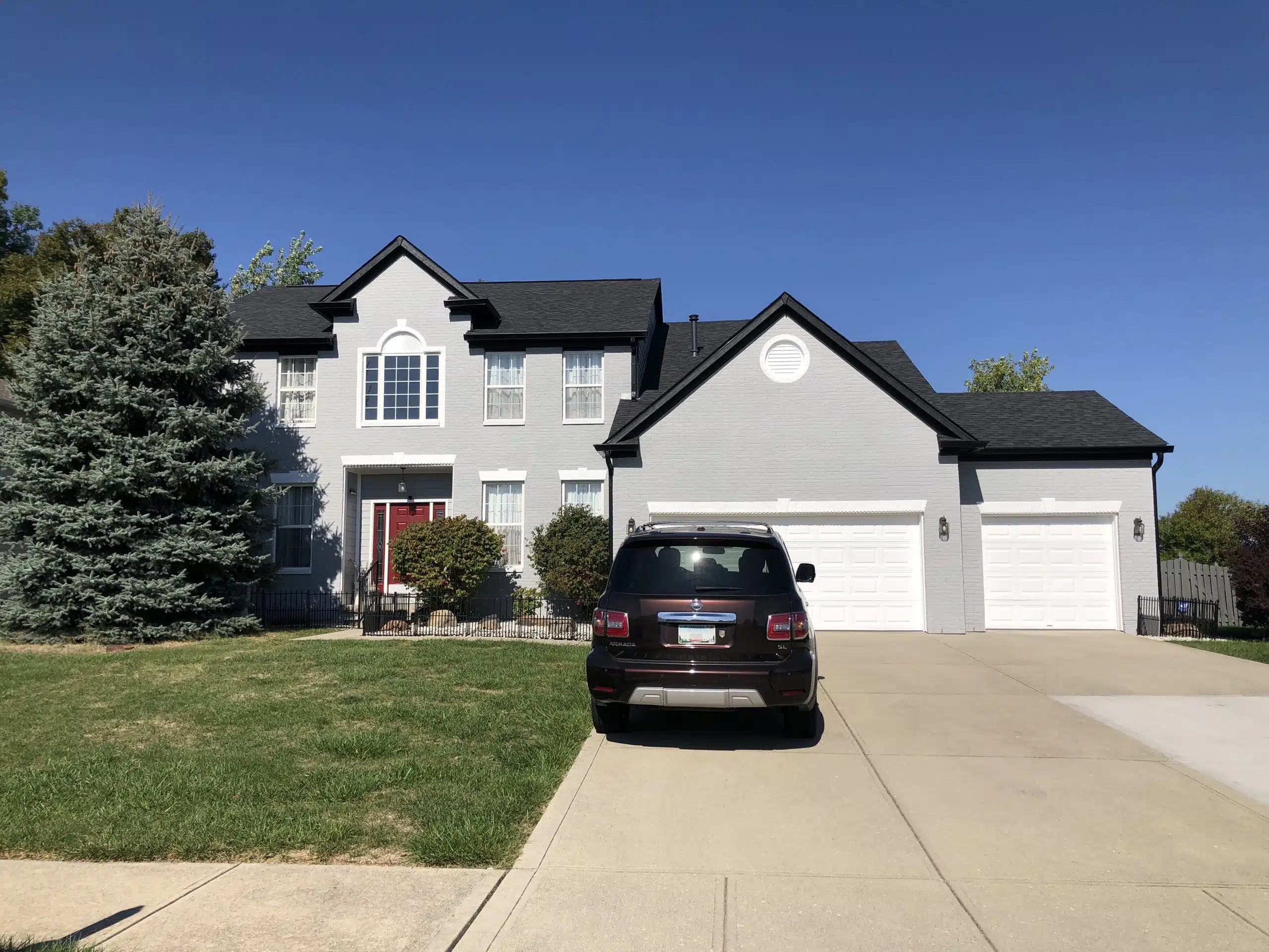 Brick House with Storm Guard Restoration Services Truck In Driveway - Indianapolis West