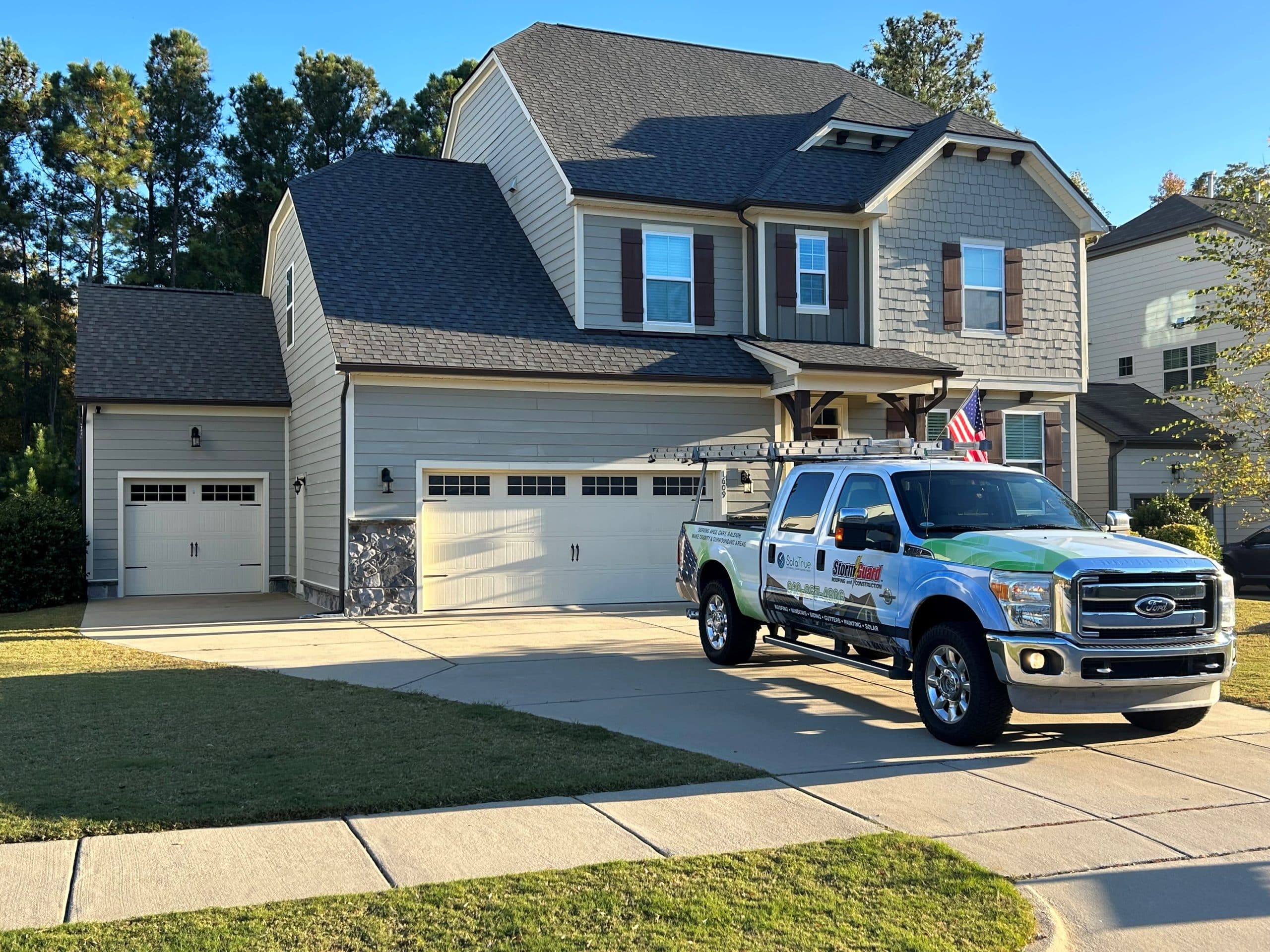 Brick House with Storm Guard Restoration Services Truck In Driveway -Apex Cary