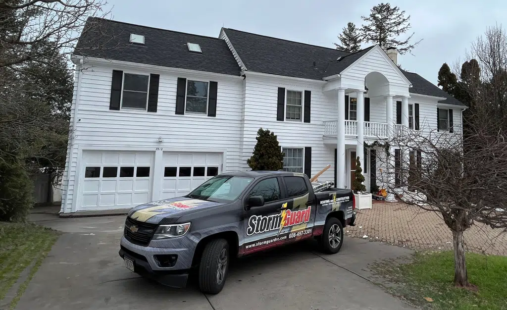 Storm Guard Car infront of  Residential Property