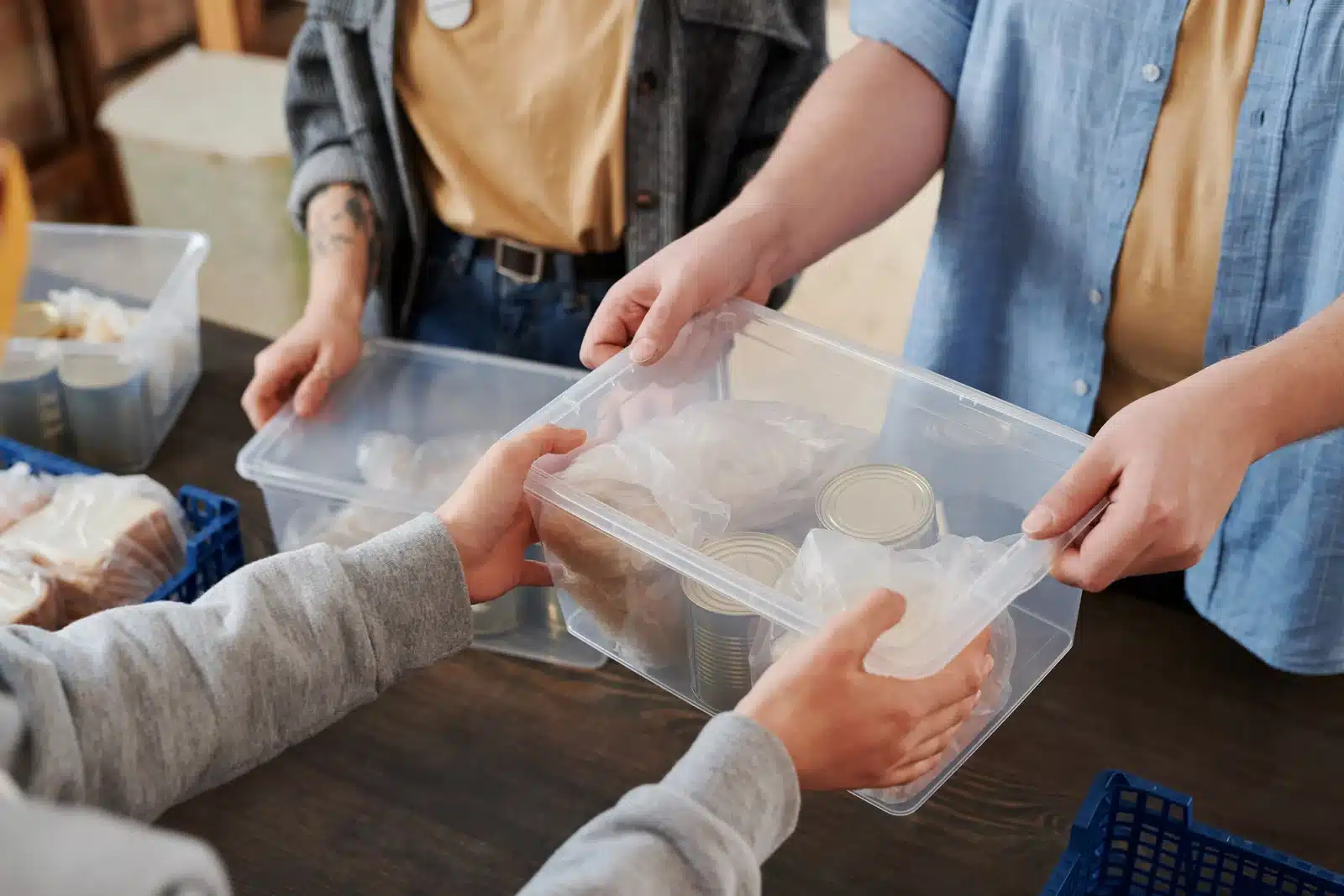 person handling over a box with food