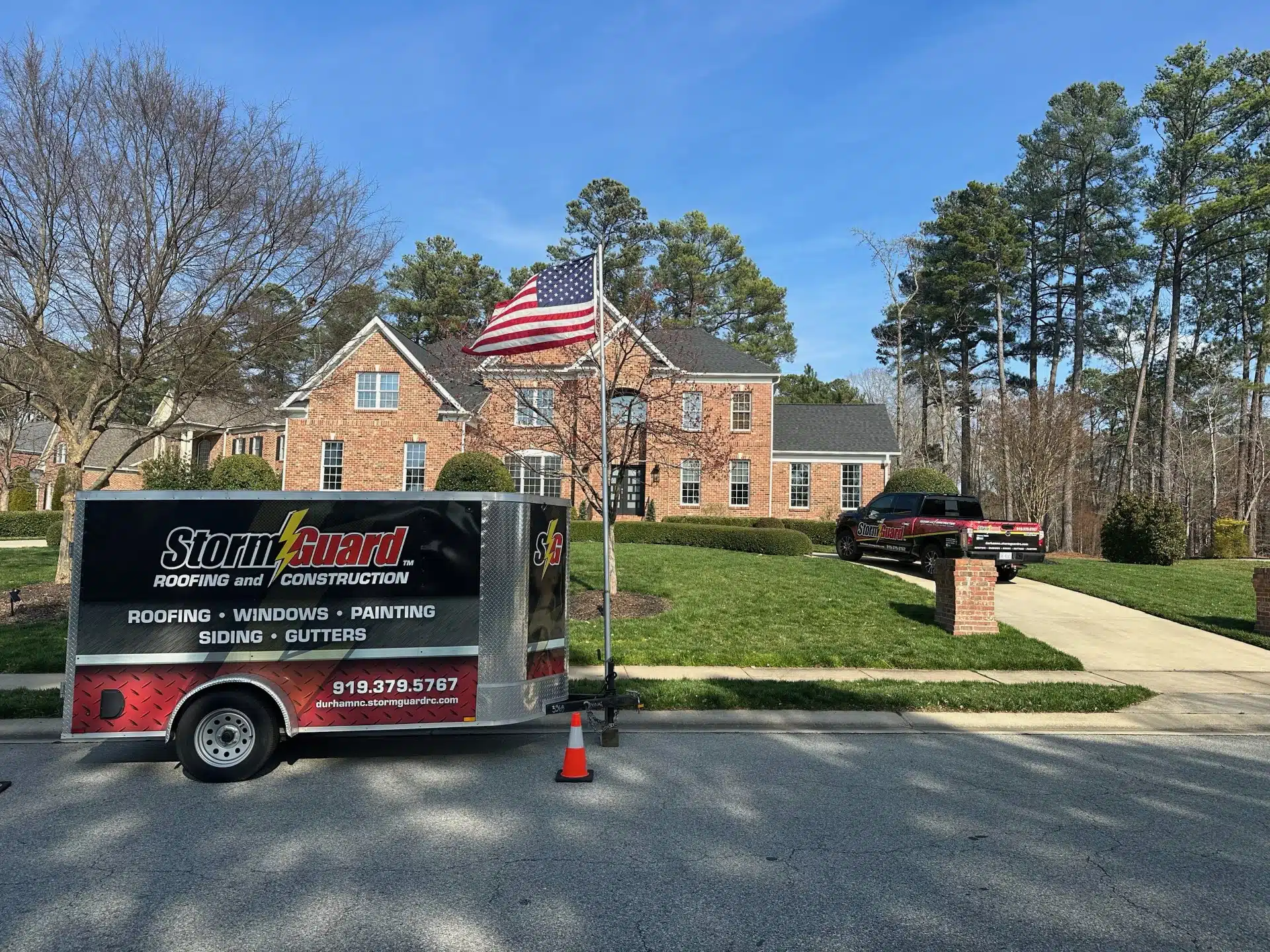 Brick House with Storm Guard Restoration Services Truck In Driveway- Durham Chapel Hill