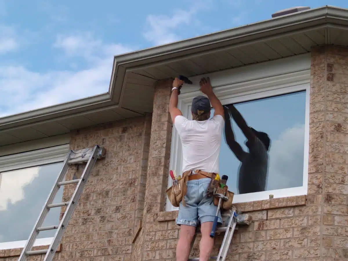 two roofers working on roof replacement 