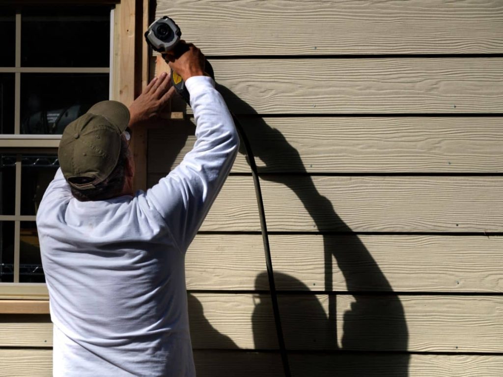 A contractor installing a siding