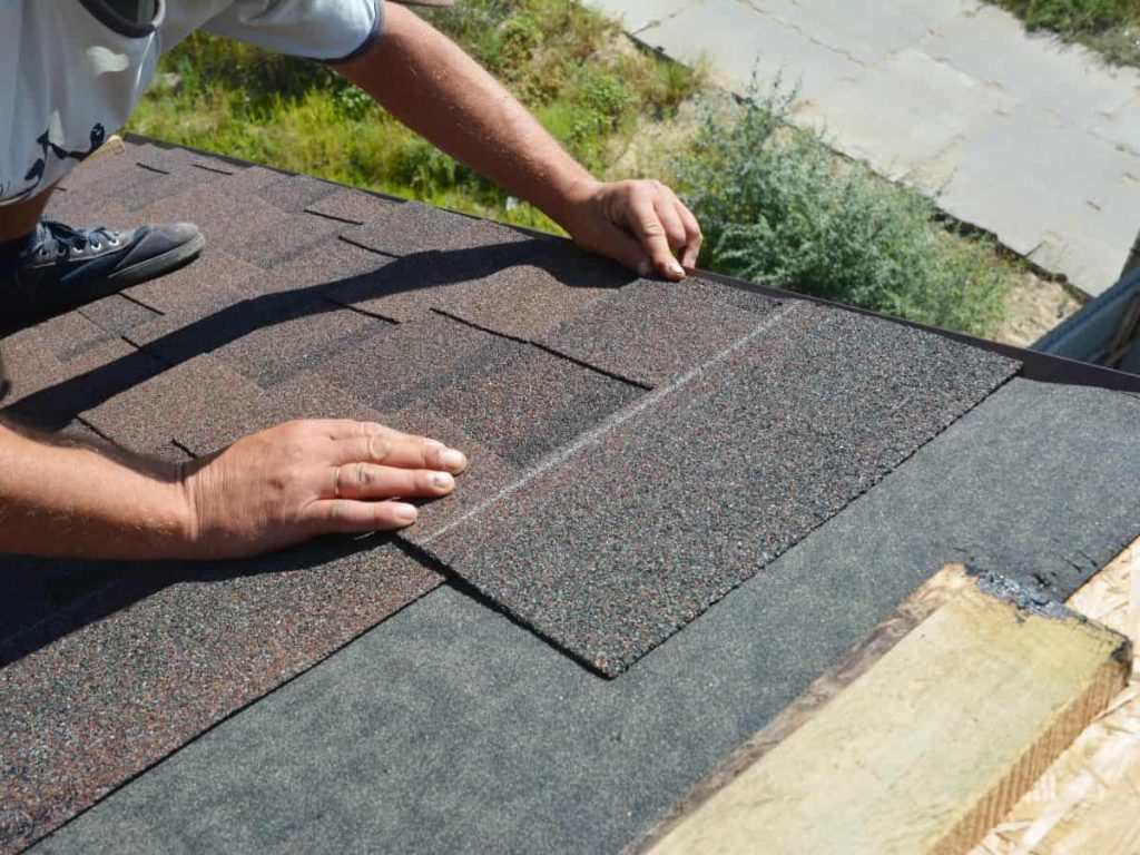 man installing asphalt shingle roof
