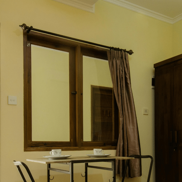 A Bed Near the Table with Chairs