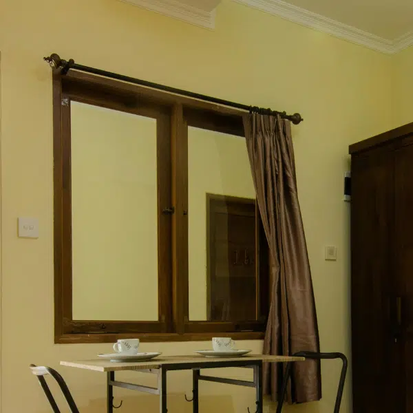 A Bed Near the Table with Chairs