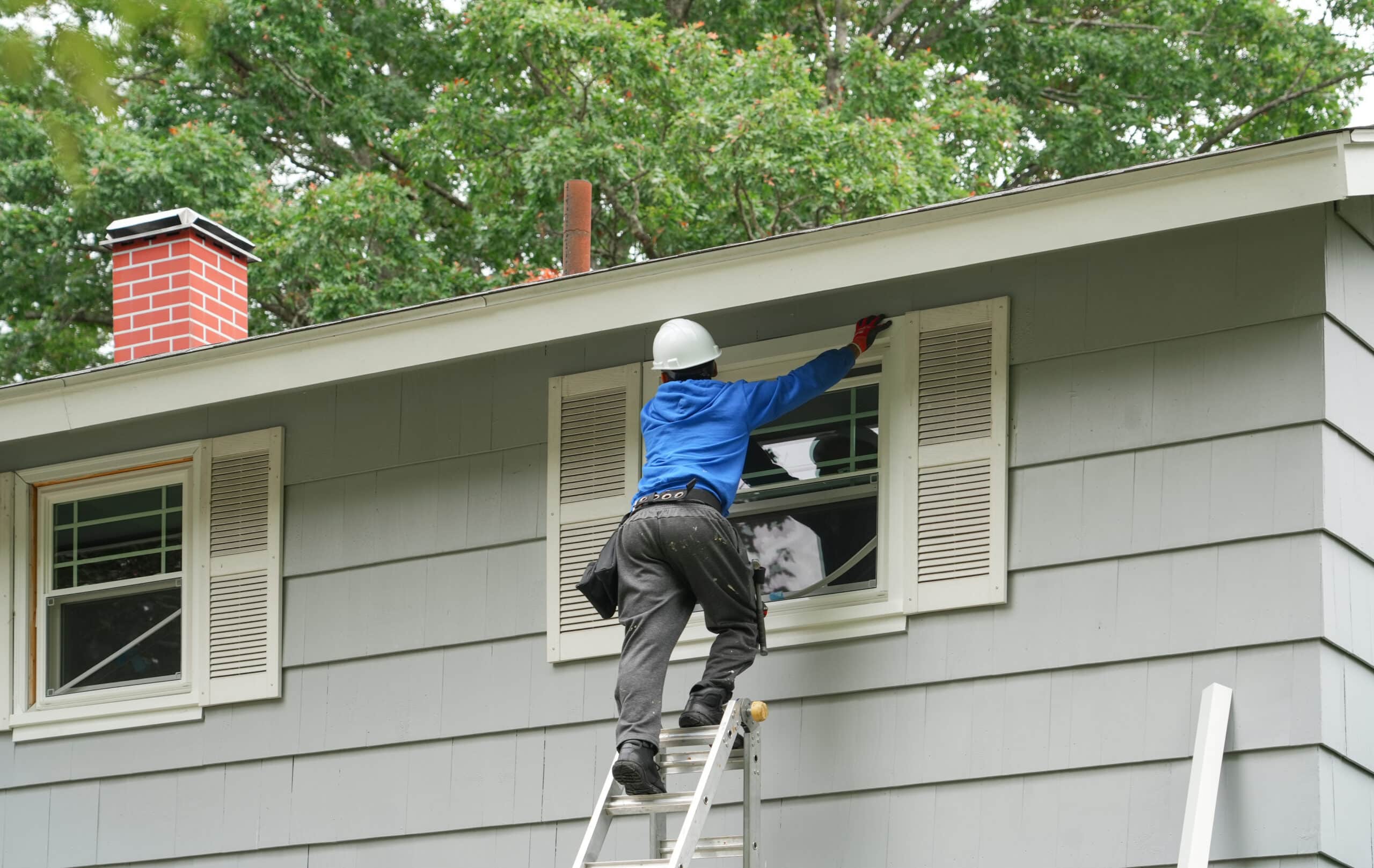 A man replacing a window