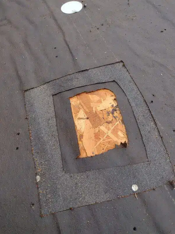 Close up view of multiple layers of felt underlayment discovered during a roof tear off in Austin, TX.